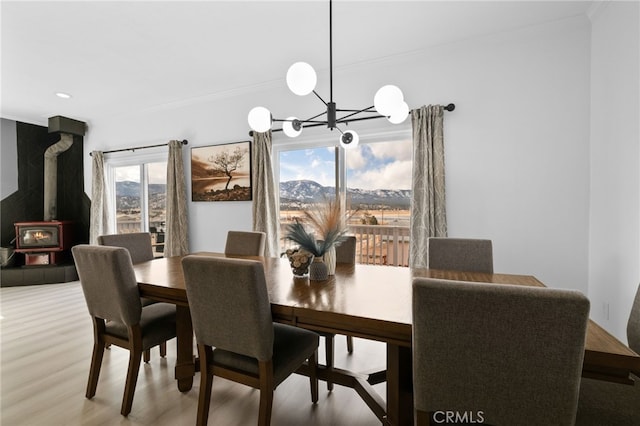 dining room featuring crown molding, wood finished floors, and a chandelier