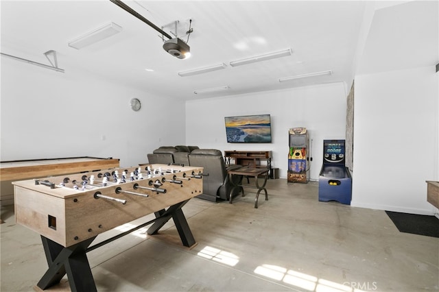 game room with a garage and concrete floors