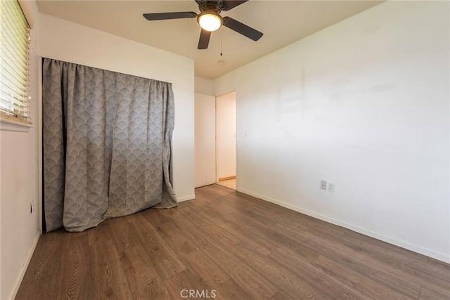 unfurnished bedroom featuring a ceiling fan, wood finished floors, and baseboards