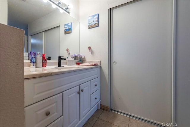 bathroom featuring tile patterned flooring and vanity