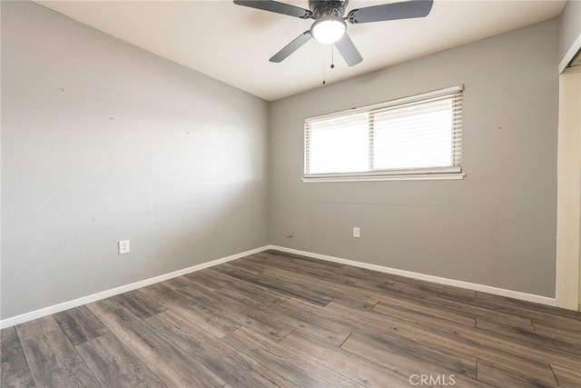 empty room with ceiling fan, baseboards, and wood finished floors