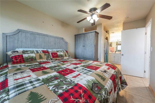 tiled bedroom with ensuite bathroom and ceiling fan