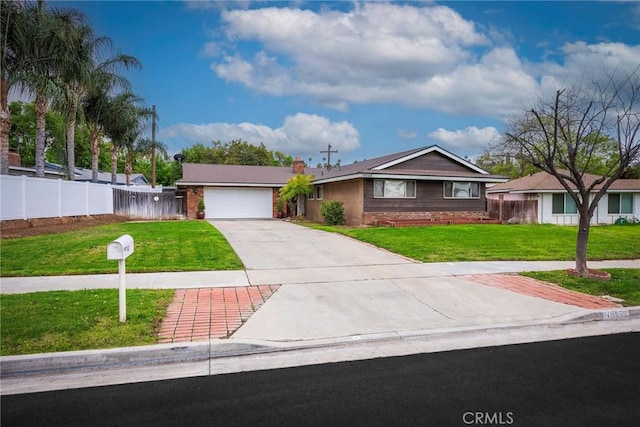 view of front of home with driveway, an attached garage, a front lawn, and fence