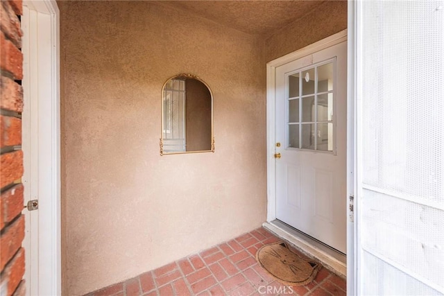 entrance to property featuring stucco siding