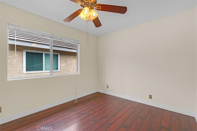 unfurnished room featuring ceiling fan, baseboards, and wood finished floors