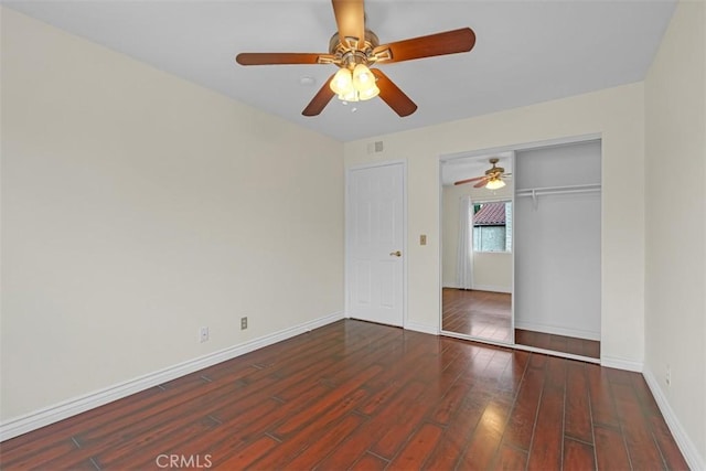 unfurnished bedroom featuring visible vents, a ceiling fan, wood finished floors, a closet, and baseboards