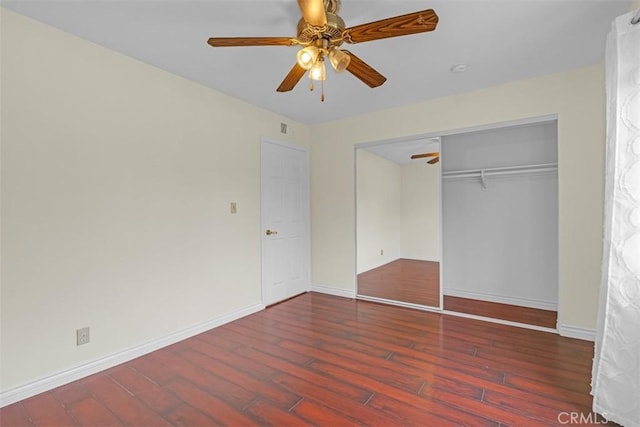 unfurnished bedroom featuring a closet, ceiling fan, baseboards, and wood finished floors