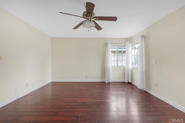 unfurnished room featuring baseboards, wood finished floors, and a ceiling fan