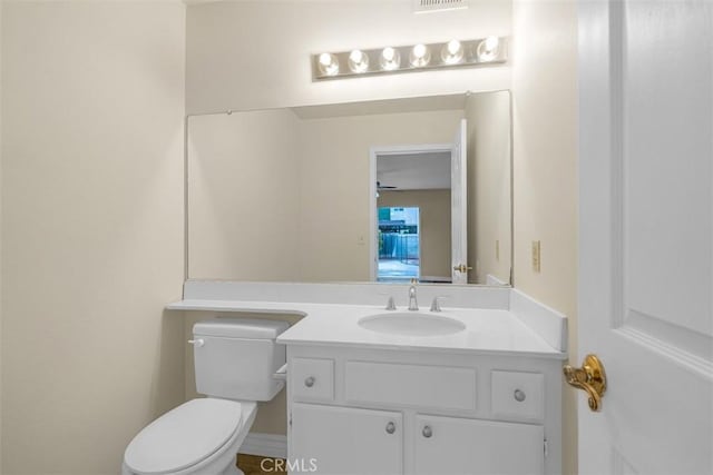 bathroom featuring toilet and vanity