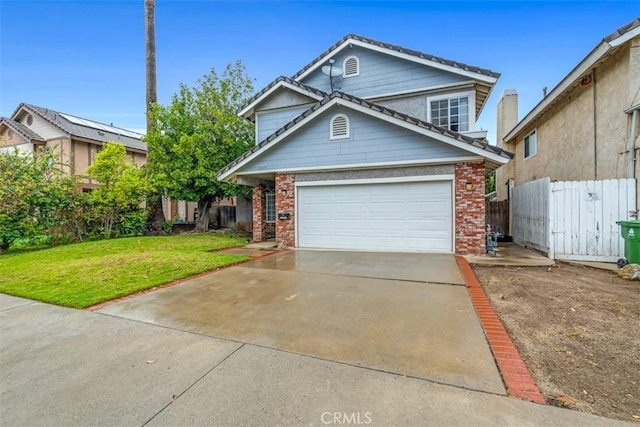 traditional-style home with brick siding, a front lawn, fence, a garage, and driveway