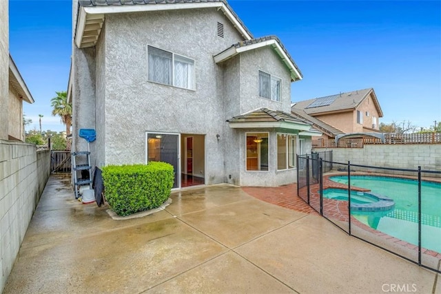 back of house featuring stucco siding, a fenced backyard, and a patio area