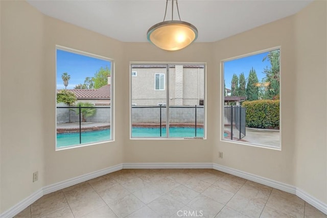 unfurnished room featuring baseboards