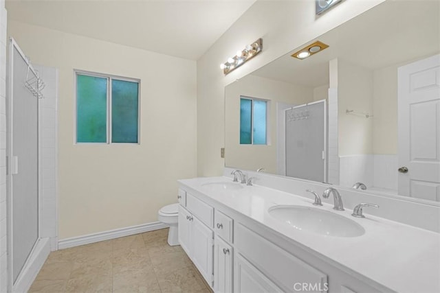 full bath with a sink, baseboards, and a shower