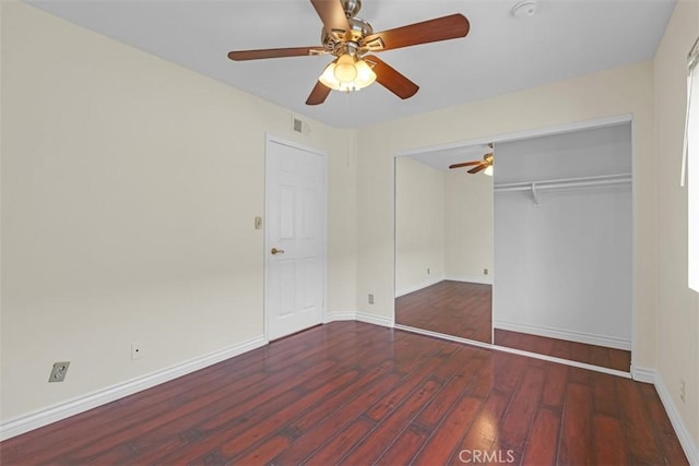 unfurnished bedroom with visible vents, baseboards, wood finished floors, a closet, and a ceiling fan