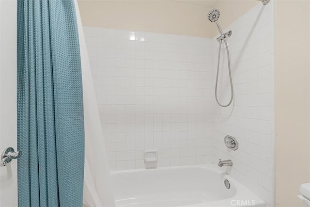 bathroom with shower / bath combination with curtain