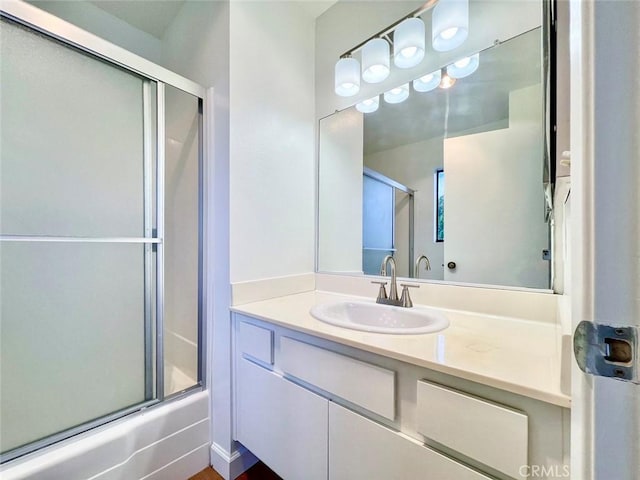 bathroom with enclosed tub / shower combo and vanity