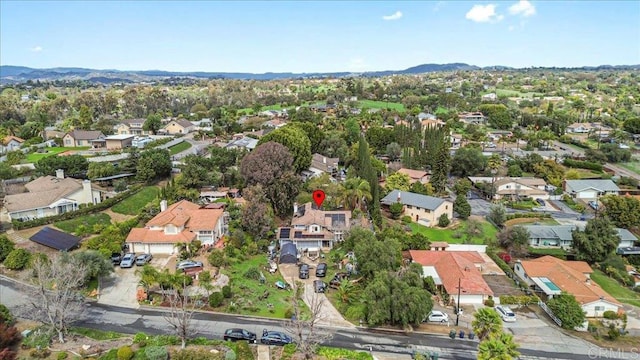 birds eye view of property with a mountain view and a residential view