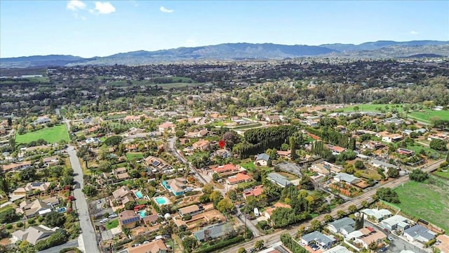 birds eye view of property with a mountain view and a residential view