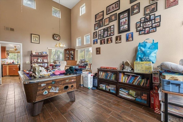 office with wood finish floors and visible vents