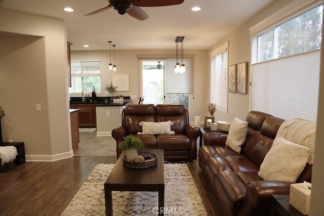 living area featuring recessed lighting, baseboards, ceiling fan, and dark wood-style flooring