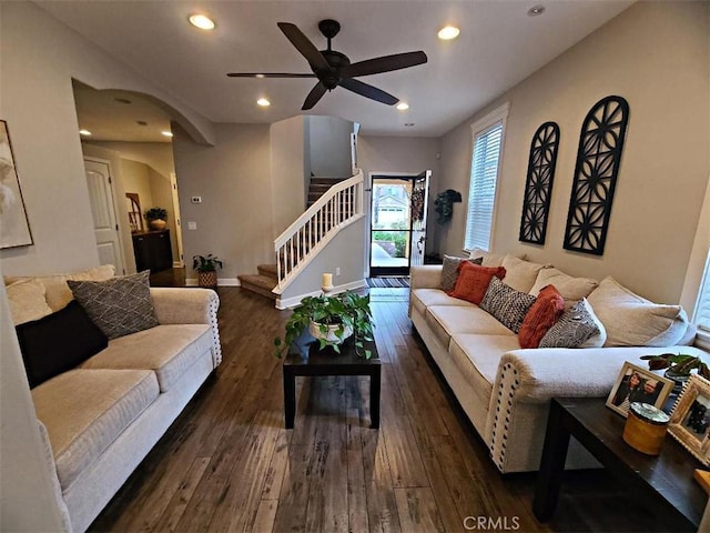 living area featuring stairway, a ceiling fan, baseboards, recessed lighting, and dark wood-type flooring