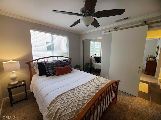 bedroom featuring visible vents, a barn door, a ceiling fan, and crown molding