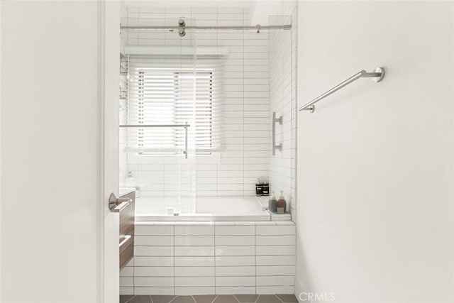 full bathroom featuring tile patterned flooring and tiled shower / bath