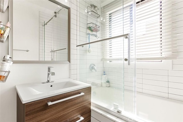 full bathroom with tiled shower / bath combo and vanity