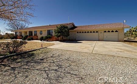 ranch-style home with stucco siding, concrete driveway, and a garage