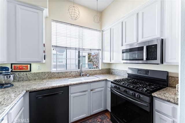 kitchen featuring a sink, stainless steel microwave, black gas stove, white cabinets, and dishwashing machine