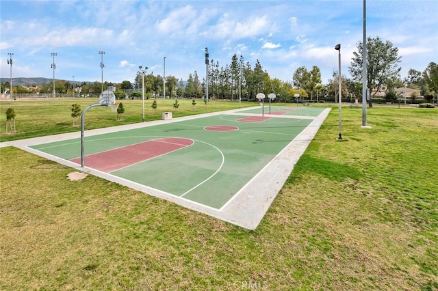 view of sport court with a lawn and community basketball court