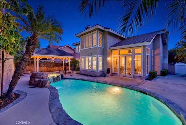 view of swimming pool with a patio area, french doors, a fenced in pool, and a fenced backyard