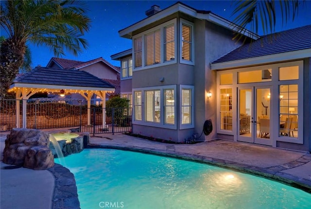 view of pool with a patio, fence, a fenced in pool, and french doors