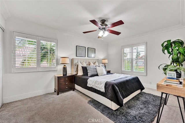 bedroom featuring ceiling fan, light colored carpet, baseboards, and ornamental molding