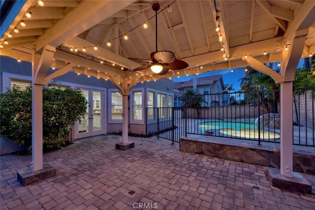 view of patio featuring a fenced in pool, french doors, ceiling fan, and fence