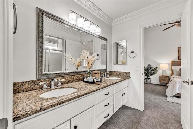 ensuite bathroom with double vanity, ornamental molding, ensuite bathroom, and a sink