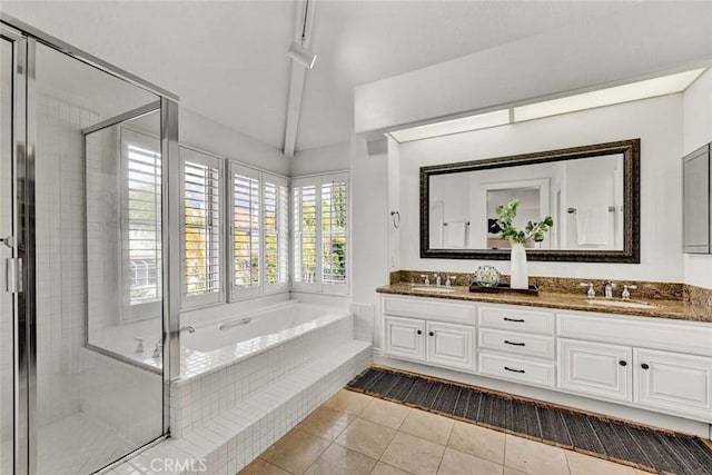 bathroom featuring tile patterned floors, a shower stall, a bath, and a sink