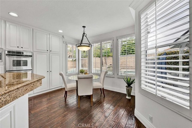 dining room featuring dark wood-style floors, recessed lighting, and baseboards