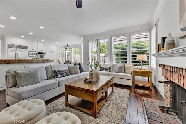 living room with recessed lighting, dark wood-style floors, baseboards, and ornamental molding