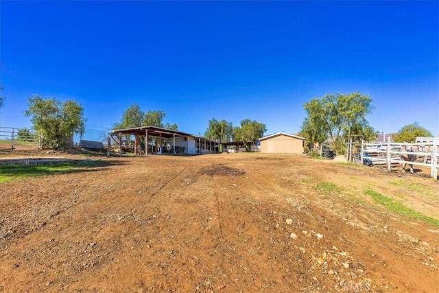 view of yard with a detached carport and fence