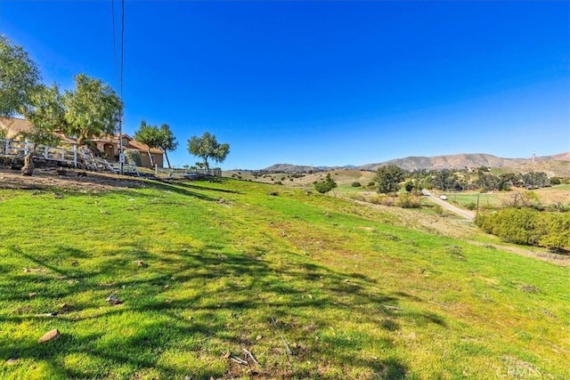 view of yard with a rural view and a mountain view