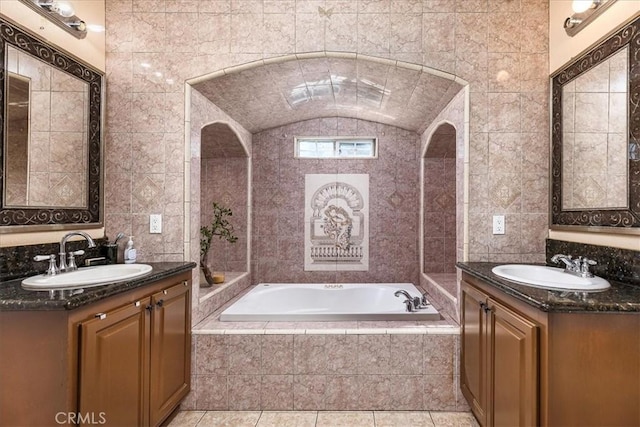 bathroom with tile walls, two vanities, and a sink