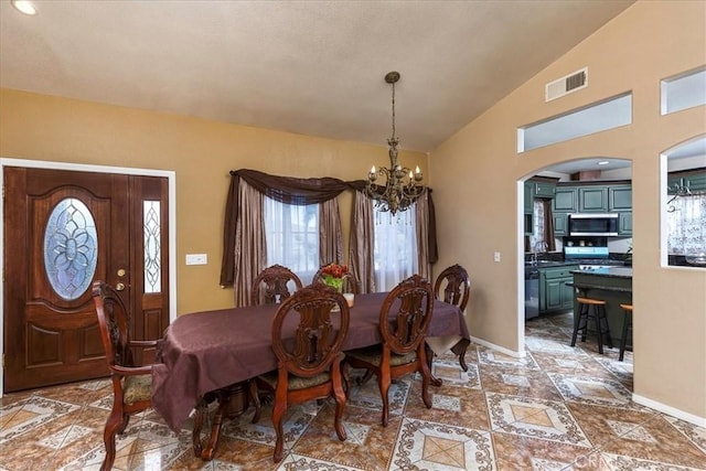 dining area featuring baseboards, visible vents, arched walkways, vaulted ceiling, and a chandelier