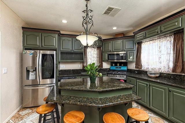 kitchen with green cabinets, visible vents, and appliances with stainless steel finishes