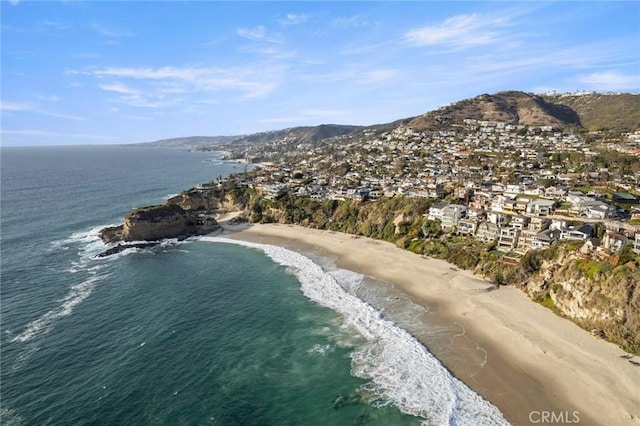 birds eye view of property with a view of the beach and a water and mountain view