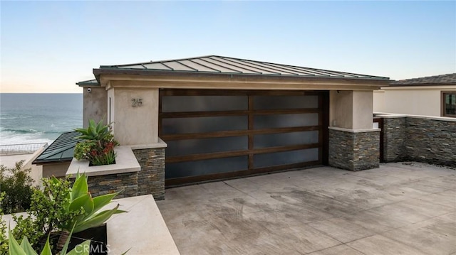 exterior space with a water view and driveway