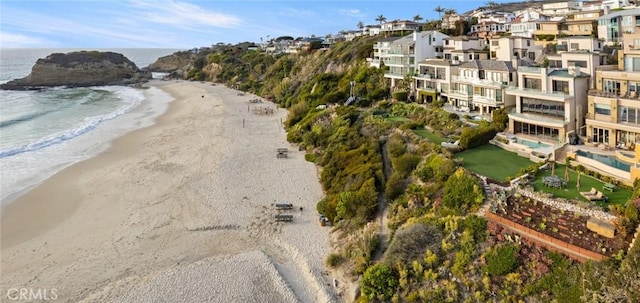 birds eye view of property with a beach view and a water view