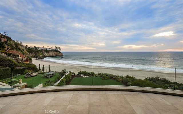 water view with fence and a beach view