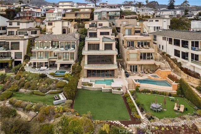 view of building exterior with a residential view and a community pool