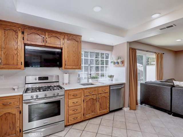 kitchen featuring a sink, light countertops, visible vents, and stainless steel appliances